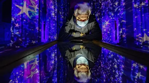 Terry-Harris.com Man at lights show in cathedral