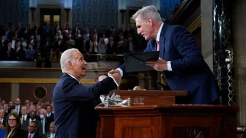 Getty Images President Joe Biden shakes hands with House Speaker Kevin McCarthy