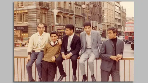 Praful Patel Praful's YMCA friends sitting on the railings at Piccadilly Circus