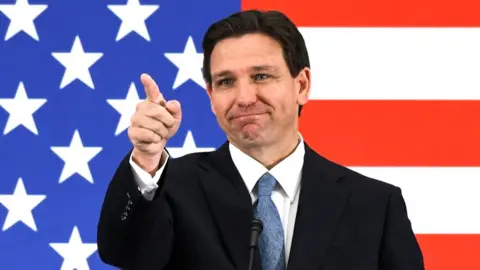 Getty Images Florida Governor Ron DeSantis calls on a member of the media at a press conference at the American Police Hall of Fame & Museum in Titusville, Florida on 1 May 2023