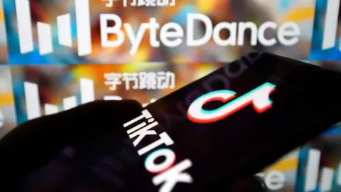 Getty Images TikTok app on smartphone next to ByteDance logo