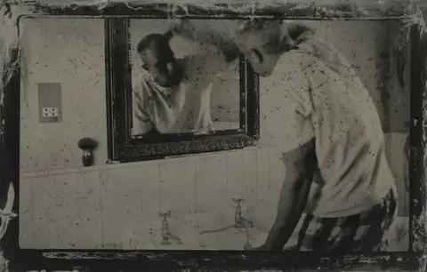 Jo de Banzie Man looking in mirror