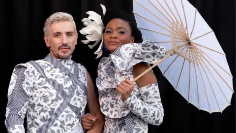 AFP Local fashionistas George Lambrou (L) and Goodness Anele (R) pose for a portrait during the 2018 edition of the Vodacom Durban July in Durban, on July 7, 2018.