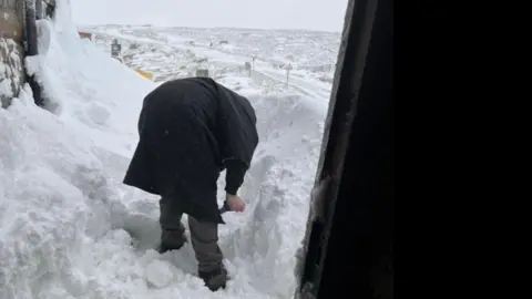 Tan Hill Inn Staff digging their way out at the Tan Hill Inn