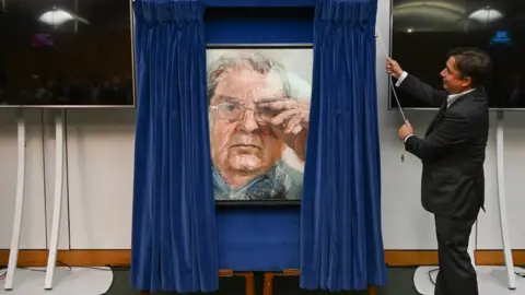UK Parliament/Jessica Taylor John Hume Jr unveils portrait of his father John Hume in parliament