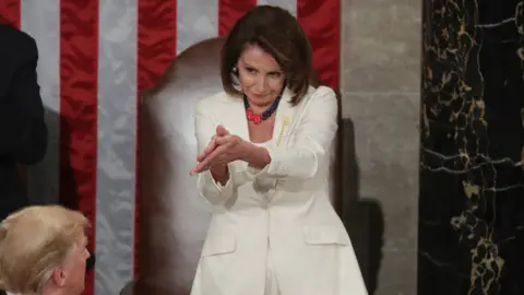 Getty Images Nancy Pelosi applauds Trump during State of the Union