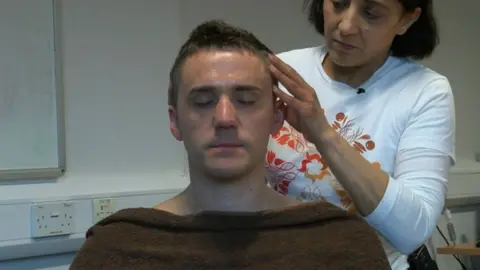 BBC A policeman being massaged