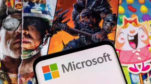 Reuters Microsoft logo in front of Activision game art