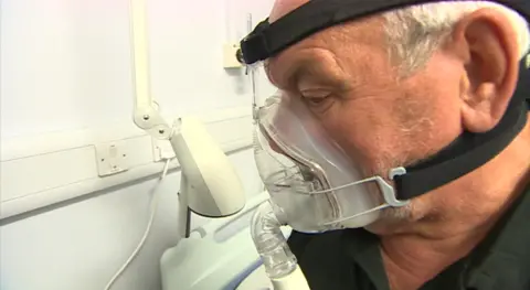 BBC Patient Mike Morgan wearing a mask that helps him to breathe during sleep