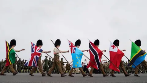 PA Media Guards carrying flags from Commonwealth countries