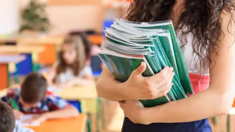 Getty Images Teacher holding books