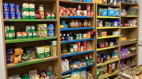Guy Campbell/BBC Shelves of food at The Leiston Pantry