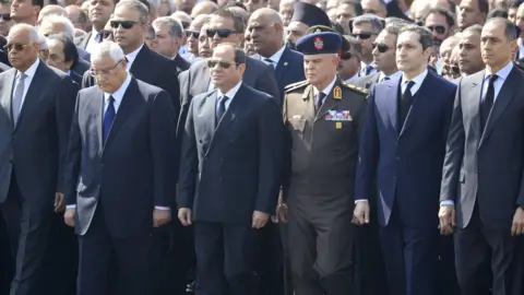 AFP President Abdul Fattah al-Sisi (C) stands near Hosni Mubarak's sons Alaa (2nd R) and Gamal (R), at a funeral in Cairo (26 February 2020)