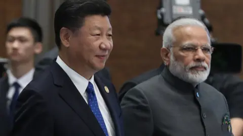 Getty Images Chinese President Xi Jinping and Indian Prime Minister Narendra Modi attend the Dialogue of Emerging Market and Developing Countries on the sidelines of the 2017 BRICS Summit in Xiamen, south-eastern China's Fujian Province on September 5, 2017