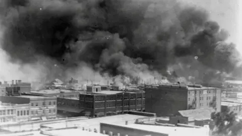 NAACP/Library of Congress via Reuters Smoke rises from buildings during the race riot in Tulsa, Oklahoma, U.S. in 1921