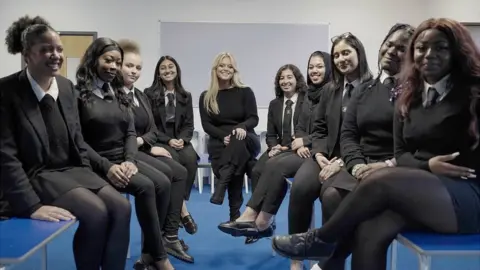 Little Gem Productions/BBC Emily with secondary school pupils