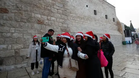 Shutterstock Women in Bethlehem taking a group selfie