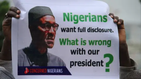 AFP/Getty Images Poster reading: "Nigerians want full disclosure. What is wrong with our president?"