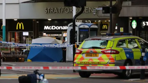 PA Media Police in Stratford, east London after a male teenager was fatally stabbed outside Stratford Broadway