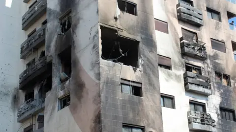 Reuters Damaged residential building in Kafr Sousa, Damascus, after what Syrian authorities said was an Israeli missile strike (21 February 2024)