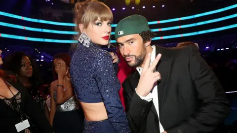 Getty Images Taylor Swift hanging out with Bad Bunny at the Grammys