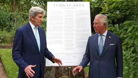 PA Media John Kerry stood next to King Charles