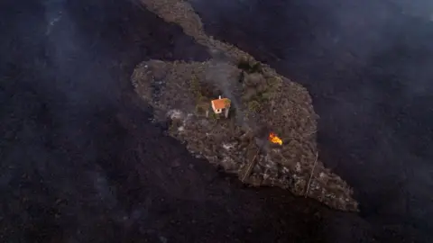 Alfonso Escalero A house sits surrounded by lava in La Palma
