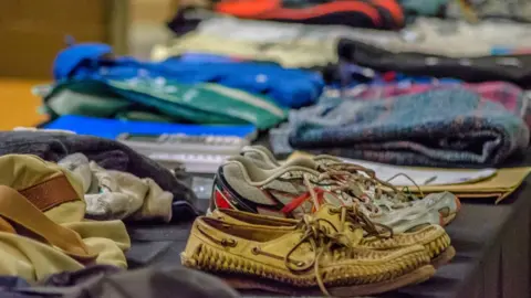 EPA Handout photo showing Otto's belongings that he took to North Korea, on display at his funeral on 22 June 2017