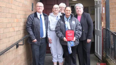 Archdiocese of Liverpool  Operations manager Brian Lowry, Ava’s aunt June White, finance director Jill Boggan, Ava’s mum Leeann White and area manager Kim Schofield