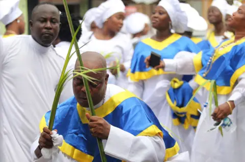 EPA Members of the Celestial Church of Christ International headquarters observe a procession on Palm Sunday, in Lagos, Nigeria, 10 April 2022