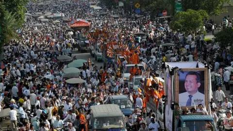 AFP/Getty Images Thousands of people take part in a funeral procession in Phnom Penh on July 24, 2016 for Kem Ley