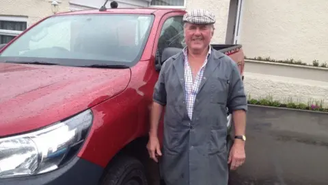 Martin Court with his truck he used for delivering milk