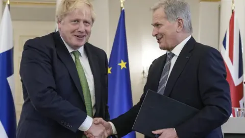 PA Media Boris Johnson at a news conference in Finland with its president Sauli Niinisto