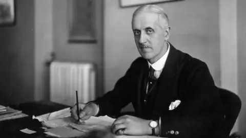 Getty Images Sir Fabian Ware sitting at his desk