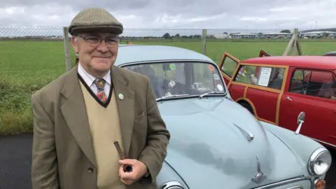 BBC Fred Tooke standing in front of a Morris Minor 1000