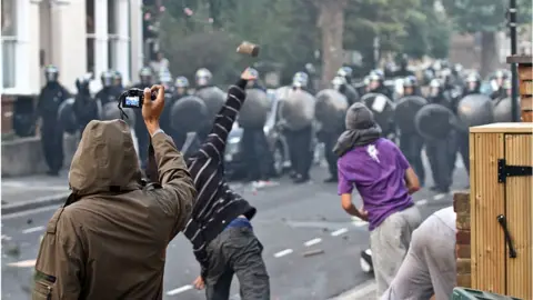 Getty Images Throwing things at the police