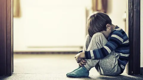 Getty Images Boy sitting on floor