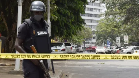 Getty Images Security measures are taken around the site after explosions that rocked Uganda's capital Kampala on November 16, 2021.