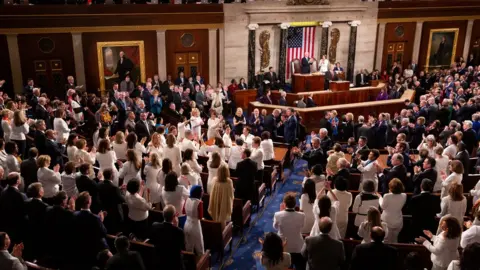 Getty Images Democratic members celebrate in the House Chamber, as President Donald Trump recognizes their achievement of electing a record number of women to Congress