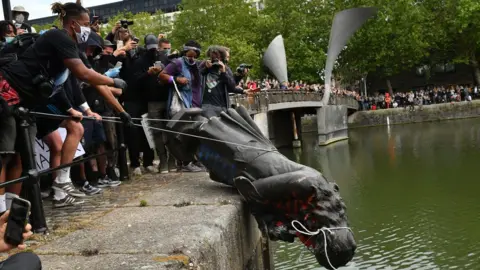 PA Media Protesters throw statue of Edward Colston into Bristol harbour