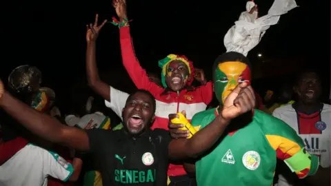 EPA Senegalese fans celebrating