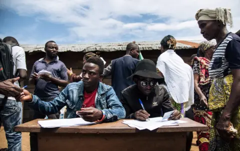 AFP People registering voters in an improvised election in the east of the country