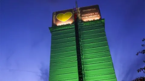 PA Media Grenfell Tower block lit up with green lights