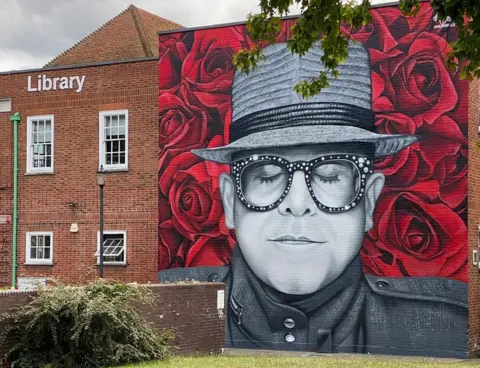 MurWalls Mural of Sir Elton John on the side of Watford Library