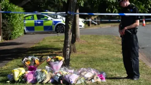 PA Media Floral tributes