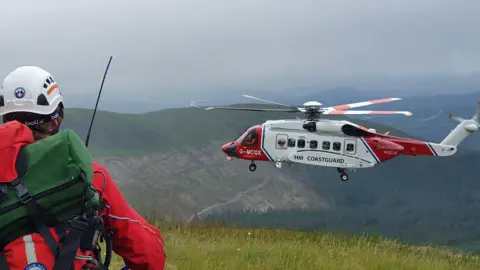 Rescue helicopter and mountain rescue team member