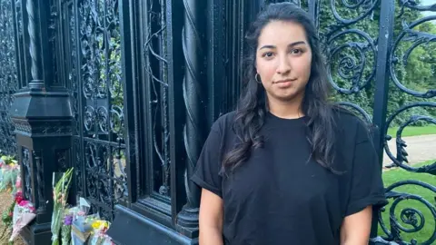 Jasmine Finbow laid flowers and crads from her family otside the gates of Sandringham