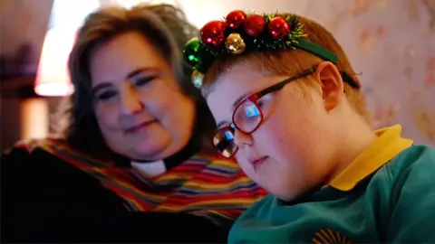 Charlotte and her son Adam watching virtual reality carols