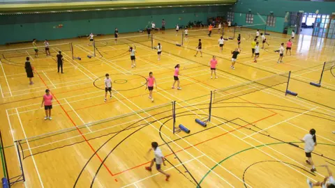 Getty Images People playing badminton in badminton courts in Hong Kong