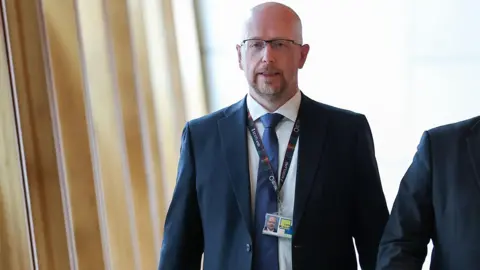 Getty Images Colin McAllister, Chief of Staff to First Minister John Swinney walking along the corridor in Holyrood